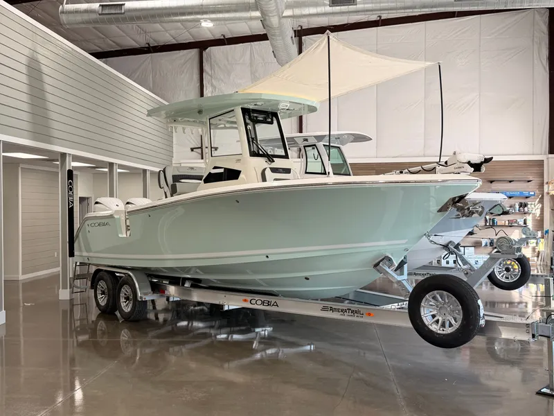 Slide: The Image of 2026 Cobia 245 Center Console boat in showroom. - 10