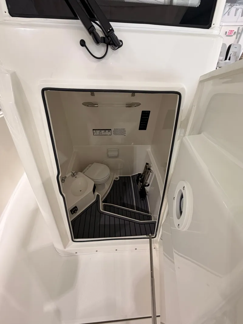 Slide: The Image of Interior of 2026 Cobia 245 Center Console with toilet. - 14