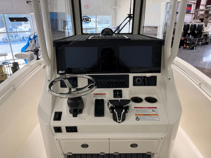 Slide: The Image of Cobia 245 Center Console 2026 helm with modern electronics. - 15