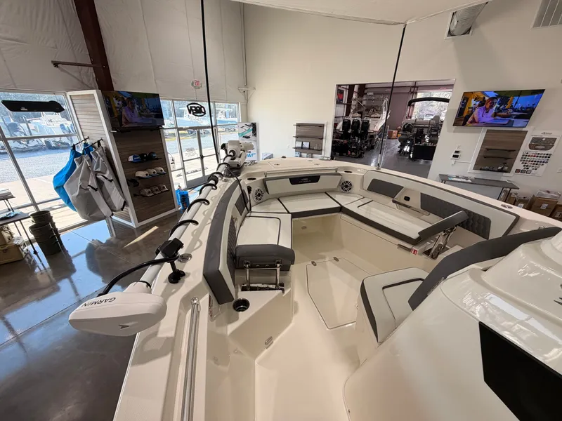 Slide: The Image of Interior view of 2026 Cobia 245 Center Console boat in showroom. - 16