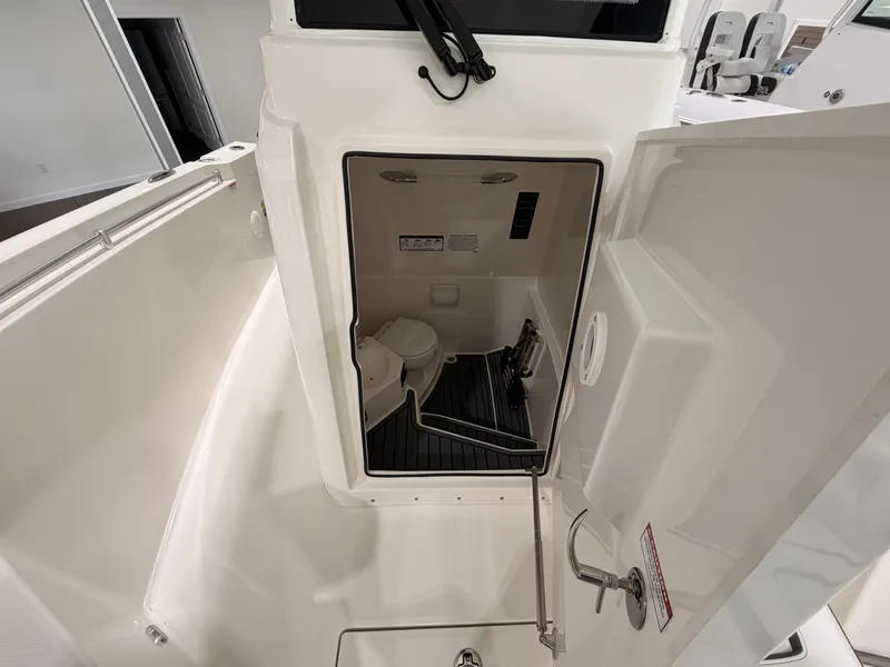 Slide: The Image of Interior of 2026 Cobia 245 Center Console with toilet. - 19