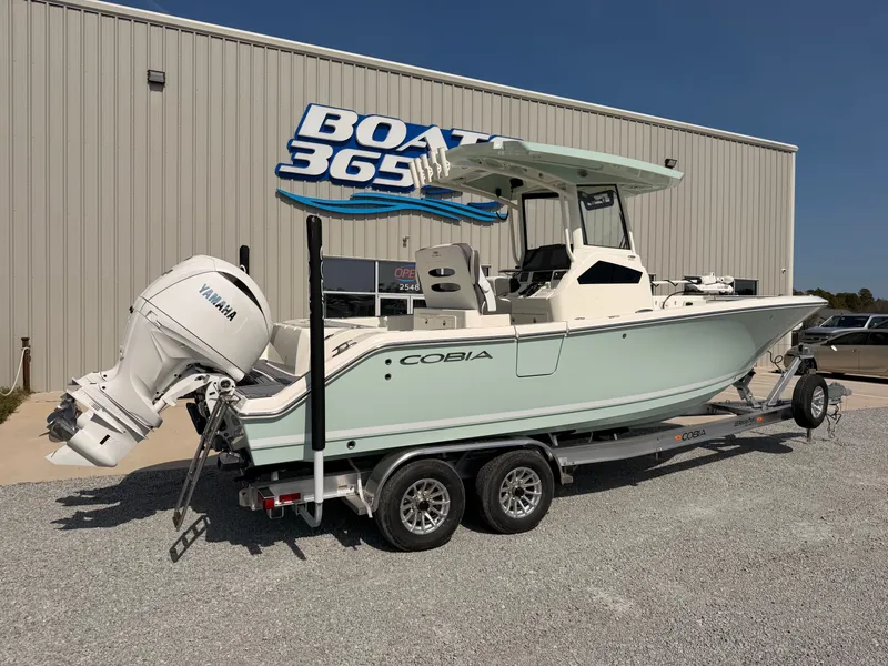 Slide: The Image of 2026 Cobia 245 Center Console boat in front of Boat 365 building. - 2