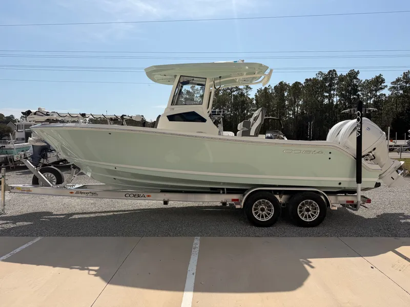 Slide: The Image of 2026 Cobia 245 Center Console on trailer outdoors. - 6
