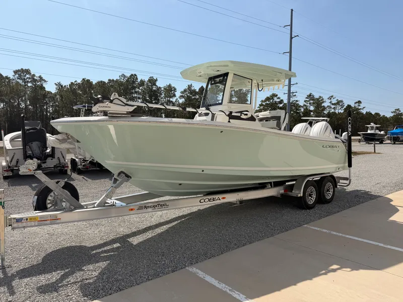 Slide: The Image of 2026 Cobia 245 Center Console on trailer outdoors. - 7