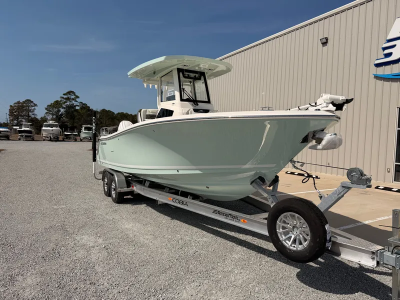 Slide: The Image of 2026 Cobia 245 Center Console on trailer outside building. - 9
