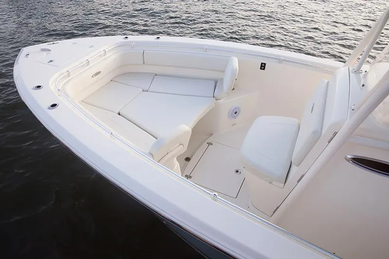 Slide: The Image of Manufacturer Provided Image: 2017 Cobia 277 Center Console boat with white seating on calm water. - 10