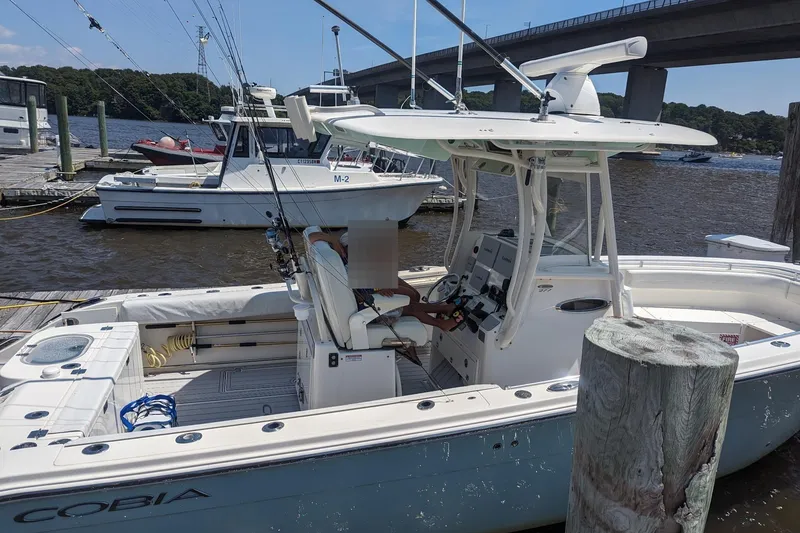 Slide: The Image of 2017 Cobia 277 Center Console boat docked. - 4