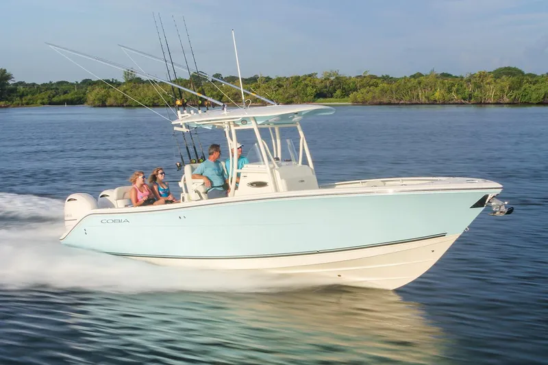 Slide: The Image of Manufacturer Provided Image: 2017 Cobia 277 Center Console boat cruising on water with passengers. - 6