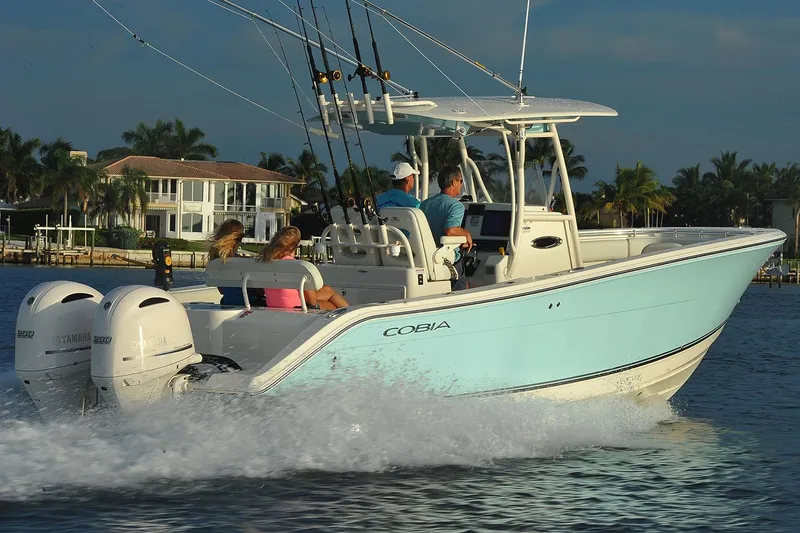 Slide: The Image of Manufacturer Provided Image: 2017 Cobia 277 Center Console boat cruising on water with passengers. - 7