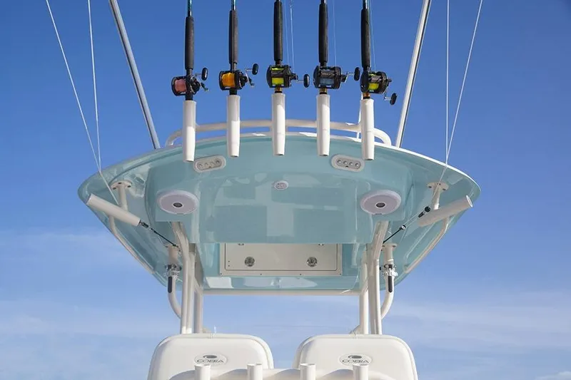 Slide: The Image of Manufacturer Provided Image: 2017 Cobia 277 Center Console with fishing rods on T-top against blue sky. - 9