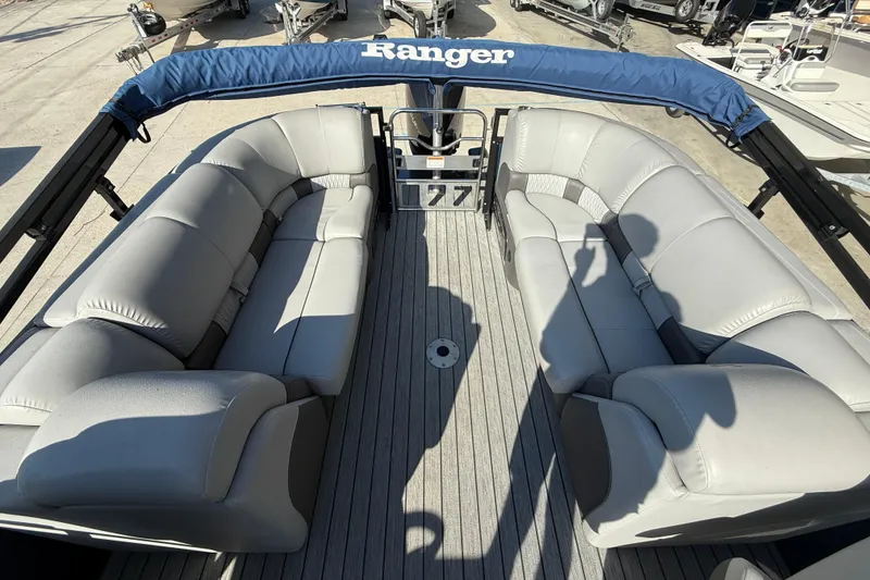 Slide: The Image of 2020 Ranger 2300LS boat interior with gray seating and blue canopy. - 11
