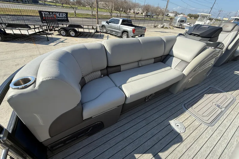 Slide: The Image of 2020 Ranger 2300LS boat with gray cushioned seating and cup holder on deck. - 13