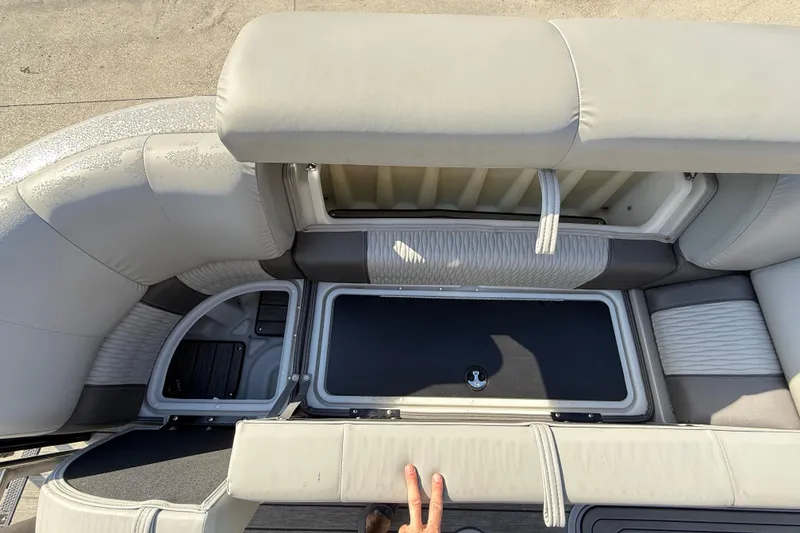 Slide: The Image of 2020 Ranger 2300LS boat interior with open storage compartments and cushioned seating. - 15