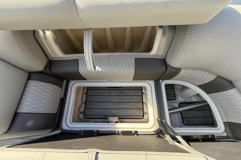 Slide: The Image of 2020 Ranger 2300LS boat interior storage compartments with cushioned seating. - 17