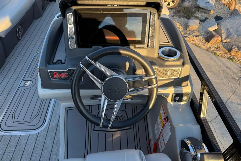 Slide: The Image of 2020 Ranger 2300LS boat dashboard with steering wheel and control panel. - 19