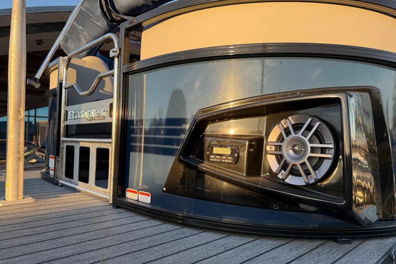 Slide: The Image of 2020 Ranger 2300LS boat with speaker system, docked at sunset. - 24