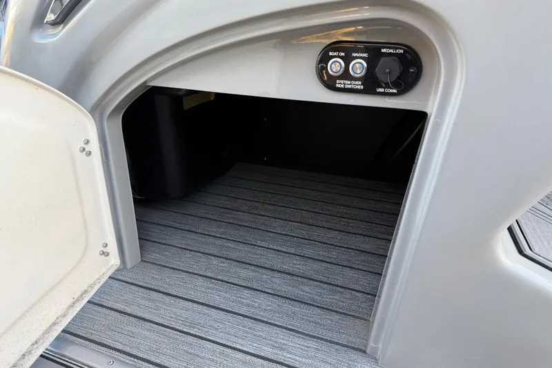 Slide: The Image of 2020 Ranger 2300LS boat storage compartment with control panel and USB connection. - 26