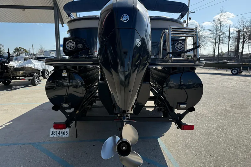Slide: The Image of 2020 Ranger 2300LS boat with outboard motor and trailer in a parking lot. - 6