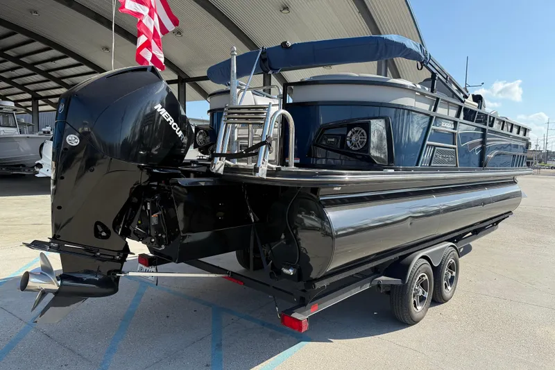 Slide: The Image of 2020 Ranger 2300LS boat with Mercury engine on trailer, under a canopy. - 7
