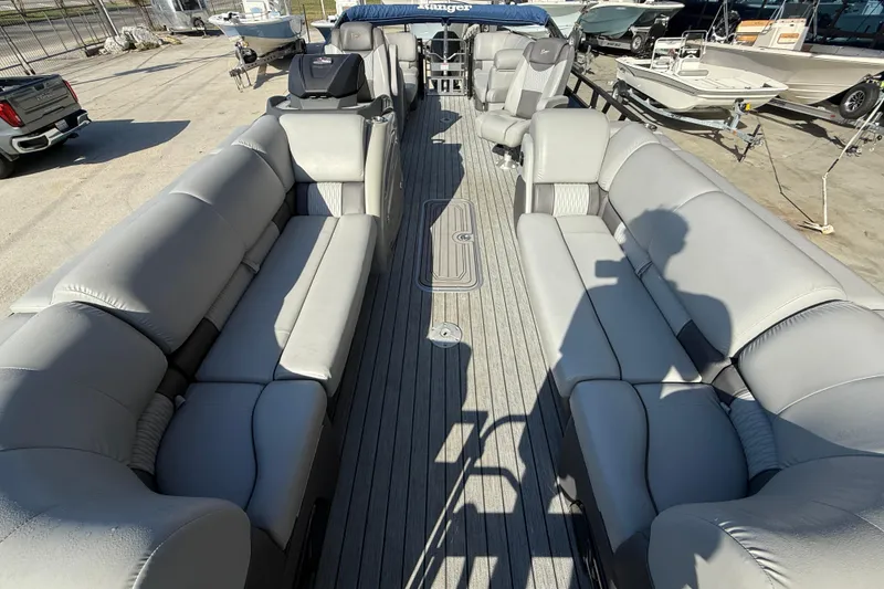 Slide: The Image of 2020 Ranger 2300LS boat interior with spacious gray seating and deck view. - 8