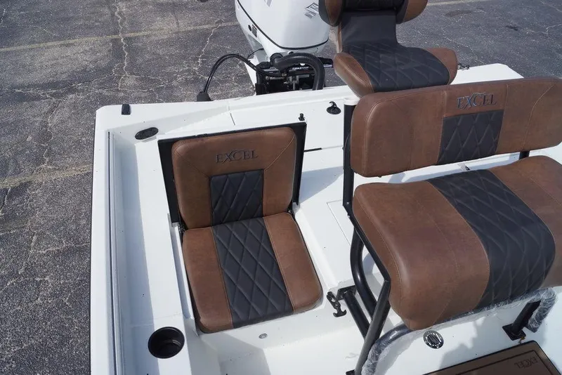 Slide: The Image of 2026 Excel 230 Bay Pro Elite boat interior with brown and black cushioned seats. - 12