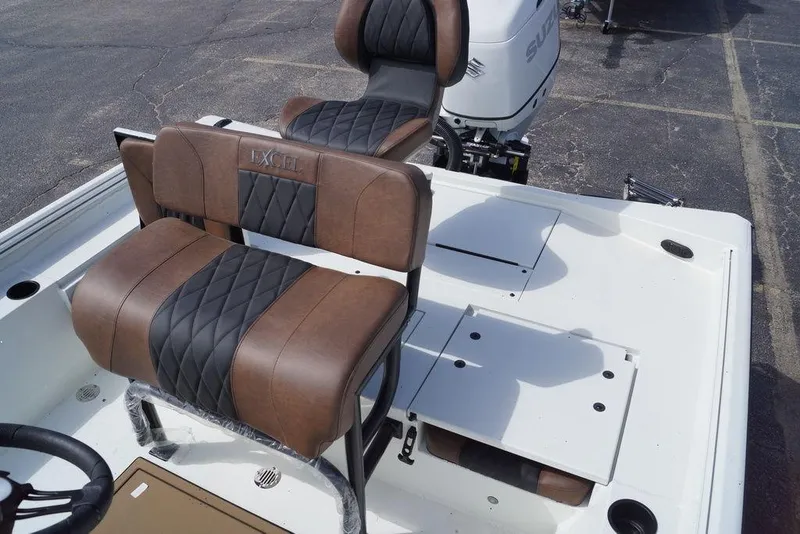 Slide: The Image of 2026 Excel 230 Bay Pro Elite boat interior with brown and black seating. - 13