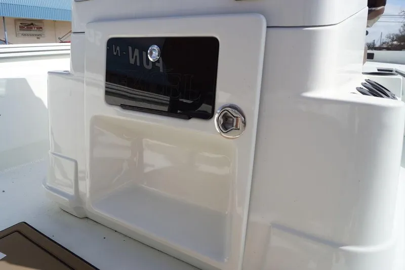 Slide: The Image of 2026 Excel 230 Bay Pro Elite boat console with storage compartment and lock. - 14