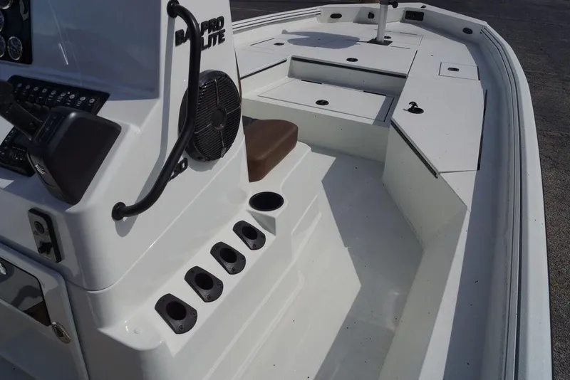 Slide: The Image of 2026 Excel 230 Bay Pro Elite boat interior with console and seating. - 16