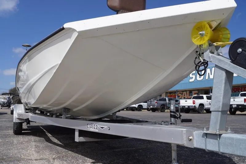 Slide: The Image of 2026 Excel 230 Bay Pro Elite boat on trailer, parked outdoors. - 21