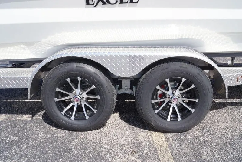 Slide: The Image of Trailer wheels of 2026 Excel 230 Bay Pro Elite boat on diamond plate fender. - 23