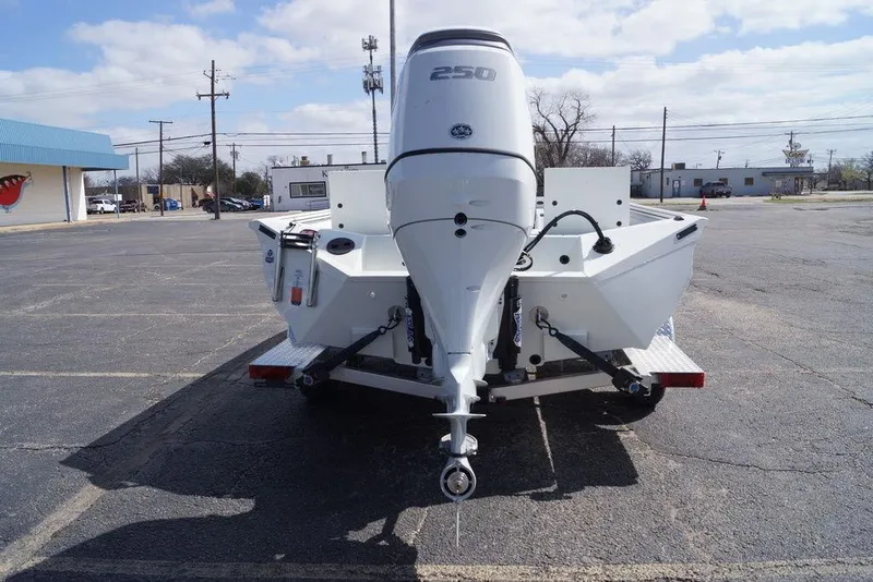 Slide: The Image of 2026 Excel 230 Bay Pro Elite boat with powerful outboard motor in a parking lot. - 24