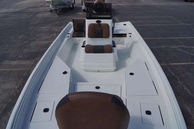Slide: The Image of 2026 Excel 230 Bay Pro Elite boat with brown seating and spacious deck layout. - 4