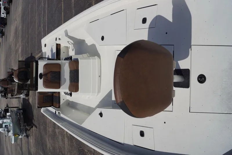 Slide: The Image of 2026 Excel 230 Bay Pro Elite boat interior with brown seating and storage compartments. - 5