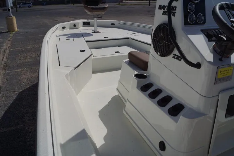 Slide: The Image of 2026 Excel 230 Bay Pro Elite boat interior with console and seating. - 9