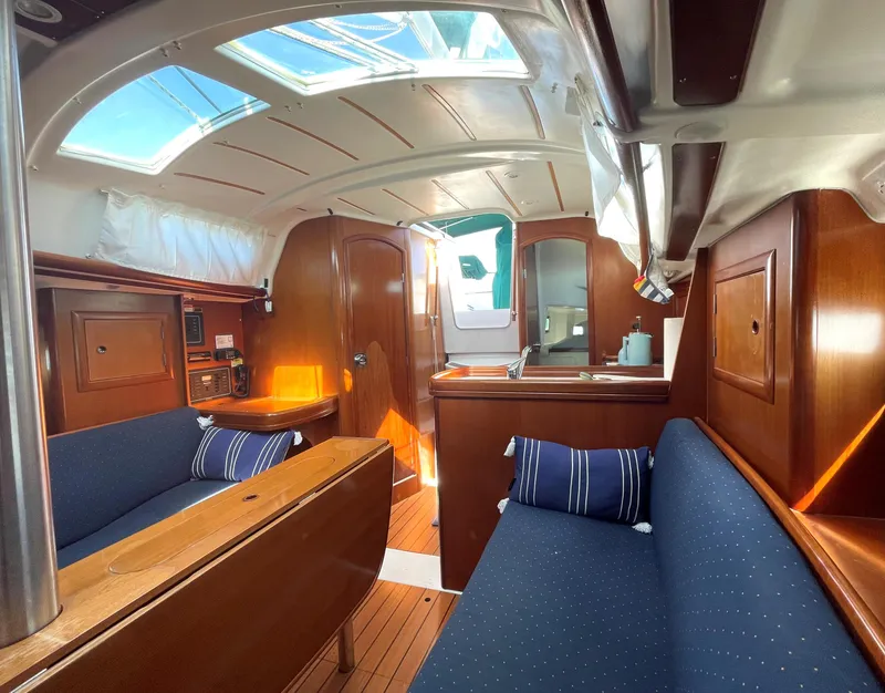 Slide: The Image of Interior of a 2005 Beneteau 323 yacht with blue upholstery. - 13