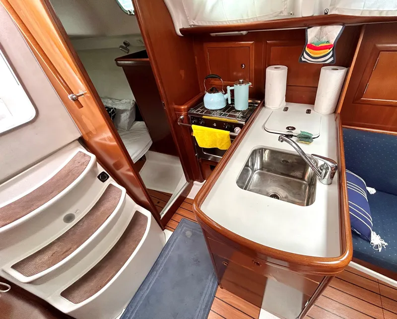 Slide: The Image of Interior of a 2005 Beneteau 323 yacht with wooden furnishings. - 14