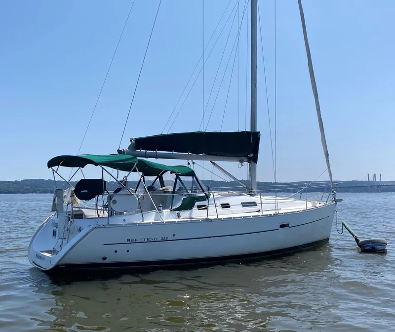 Slide: The Image of 2005 Beneteau 323 sailboat on calm water. - 3