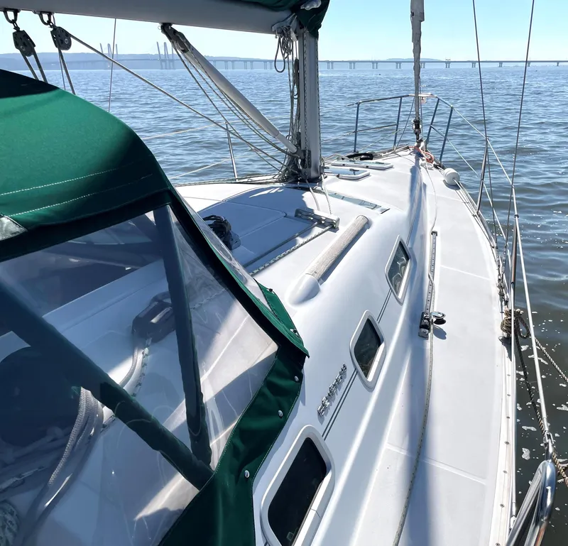 Slide: The Image of Deck of a 2005 Beneteau 323 sailboat on calm water. - 8