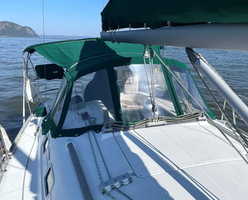 Slide: The Image of 2005 Beneteau 323 sailboat on calm waters. - 9