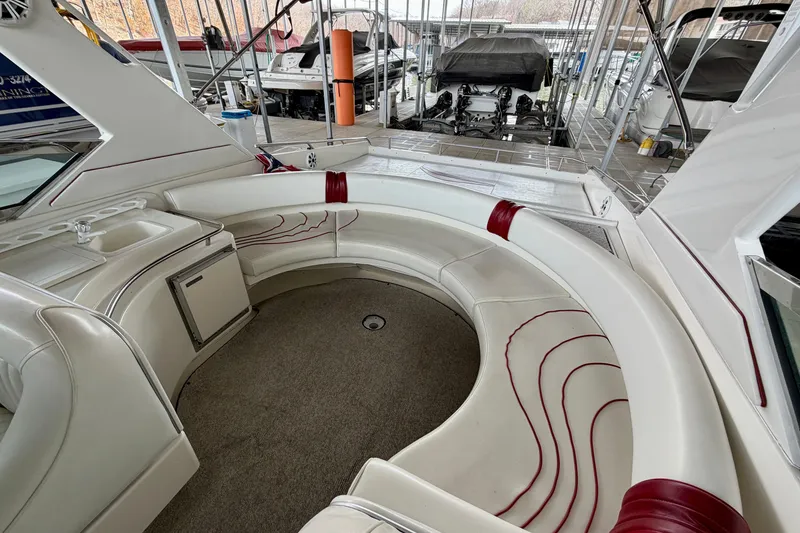 Slide: The Image of 1995 Sea Ray 380 Sun Sport interior with curved seating and compact sink area. - 11