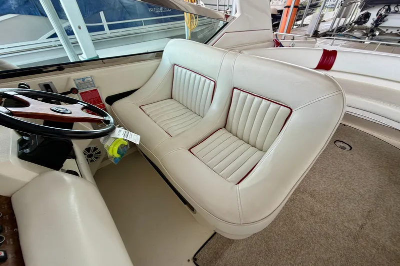 Slide: The Image of 1995 Sea Ray 380 Sun Sport interior with white leather seating and steering wheel. - 12