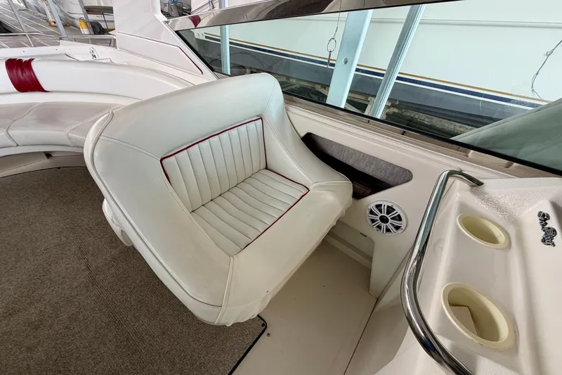 Slide: The Image of 1995 Sea Ray 380 Sun Sport interior with white seating and cup holders. - 13