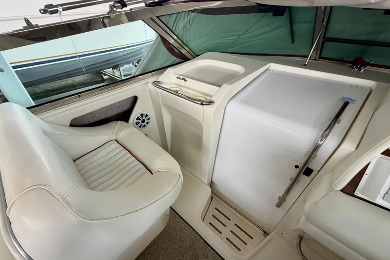 Slide: The Image of 1995 Sea Ray 380 Sun Sport interior with white seating and control panel. - 14