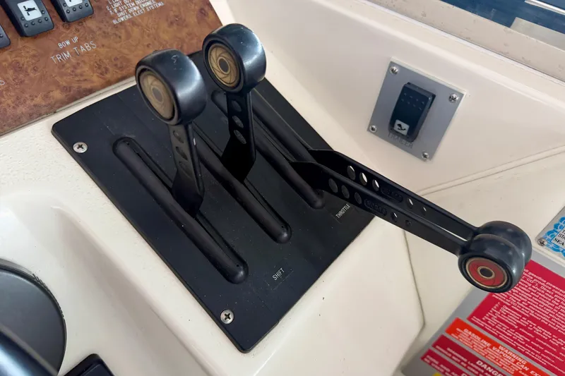 Slide: The Image of 1995 Sea Ray 380 Sun Sport throttle controls on boat dashboard. - 21