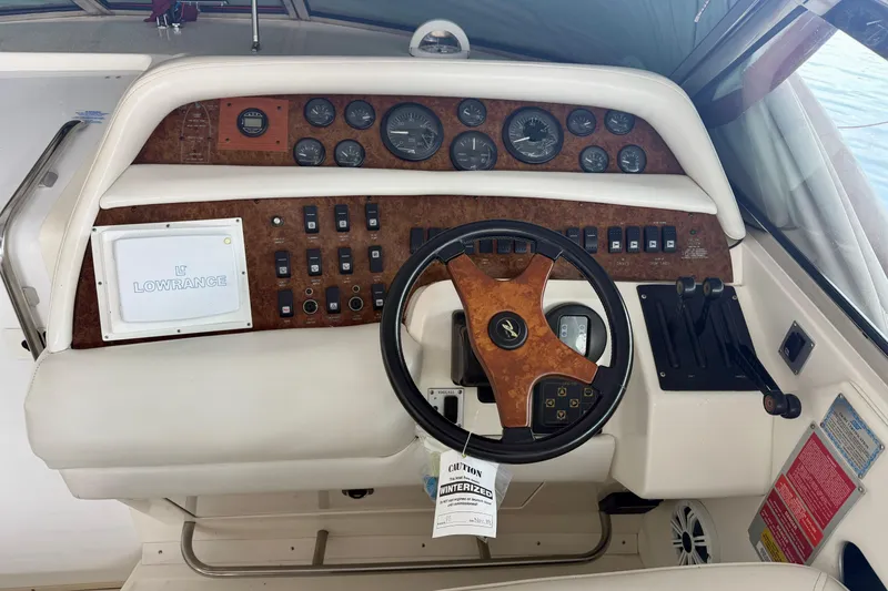 Slide: The Image of 1995 Sea Ray 380 Sun Sport dashboard with steering wheel and control panel. - 22