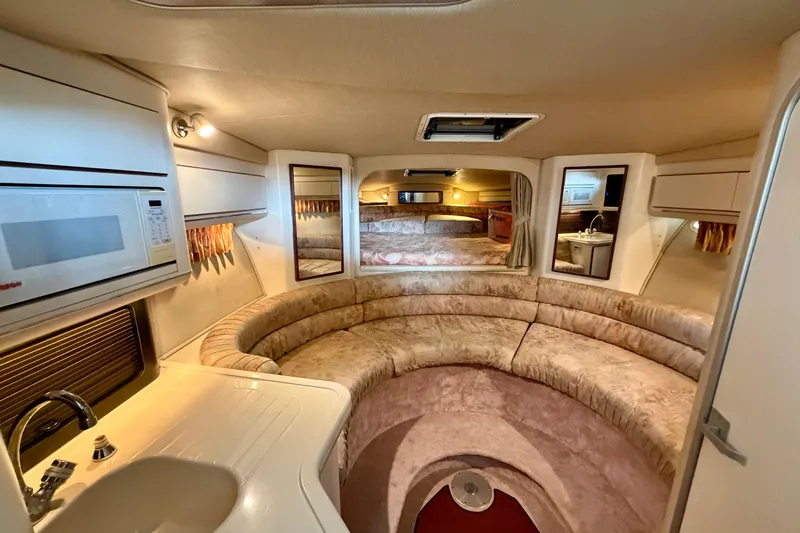 Slide: The Image of Luxurious interior of 1995 Sea Ray 380 Sun Sport with cozy seating and kitchenette. - 25