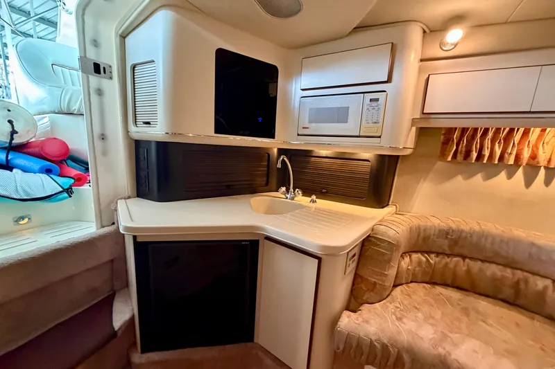 Slide: The Image of Interior of 1995 Sea Ray 380 Sun Sport with kitchenette and seating area. - 28