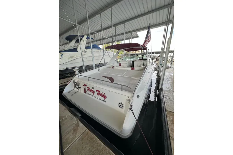 Slide: The Image of 1995 Sea Ray 380 Sun Sport docked under a covered marina. - 3