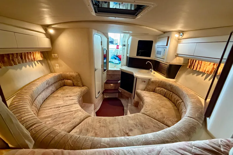 Slide: The Image of Luxurious interior of a 1995 Sea Ray 380 Sun Sport boat with plush seating and kitchenette. - 33