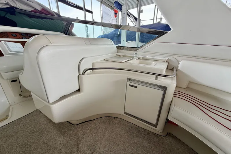 Slide: The Image of Interior of a 1995 Sea Ray 380 Sun Sport boat with seating and mini-fridge. - 9